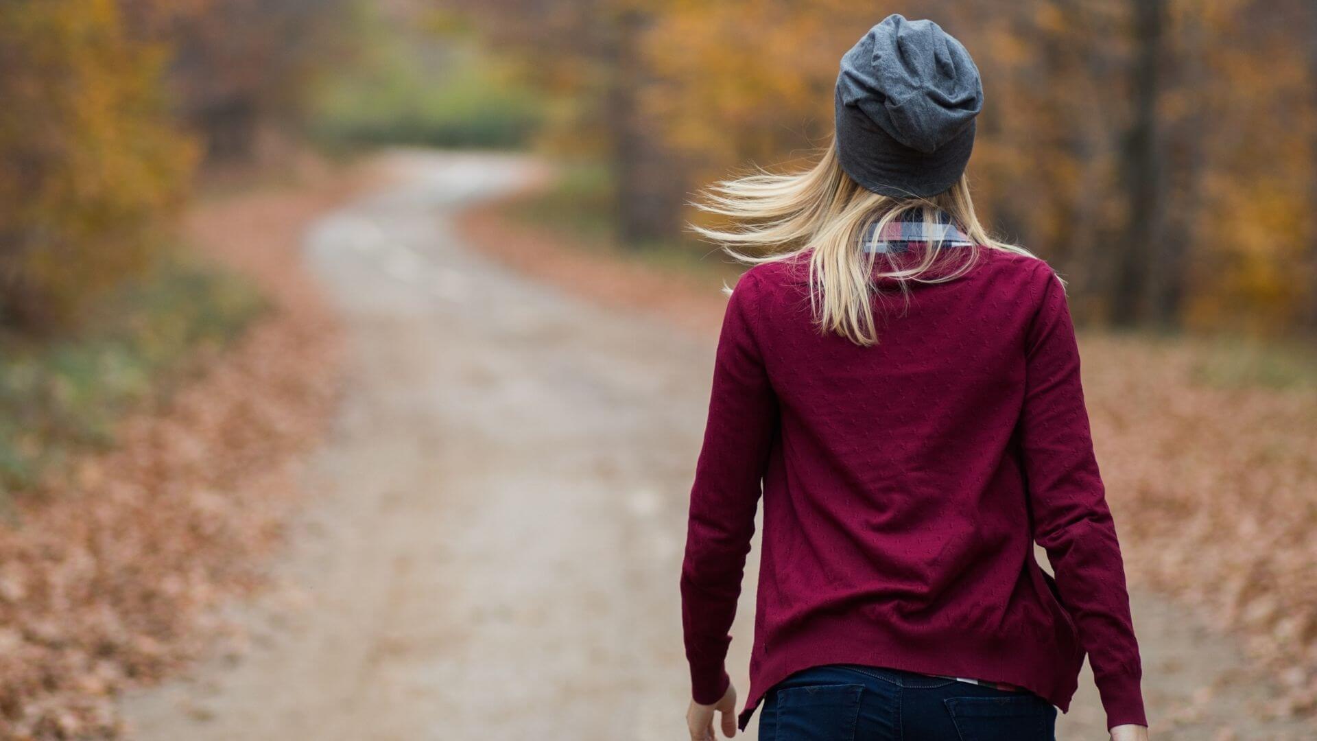 5 steps to reset your life — without starting over Woman walking through an autumn forest, symbolizing reflection, letting go, and a soulful life reset amidst seasonal change.