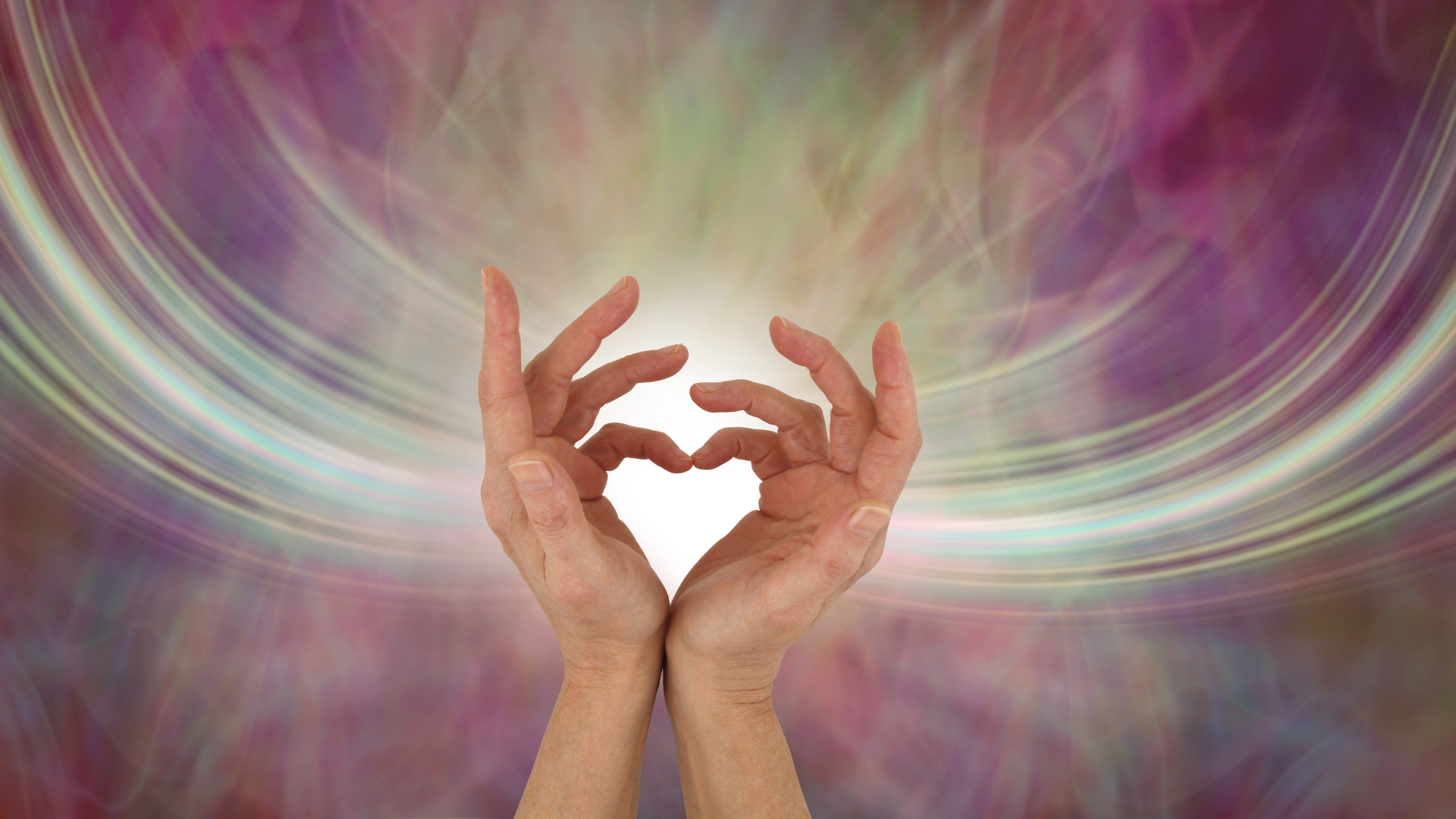 Two hands forming a heart shape with radiant light behind them — symbolizing connection, care, and the healing power of open-hearted communication.